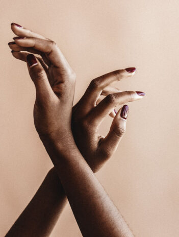 Hands of a Black woman delicately raised in the air