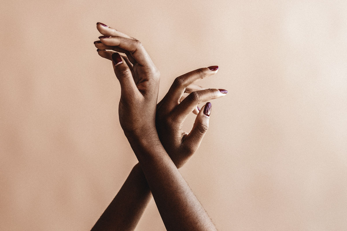 Hands of a Black woman delicately raised in the air